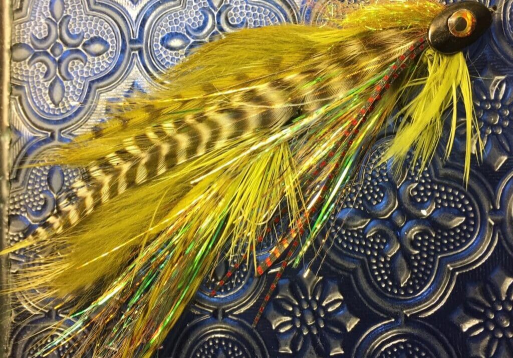 Yellow feathered fishing lure with bead head